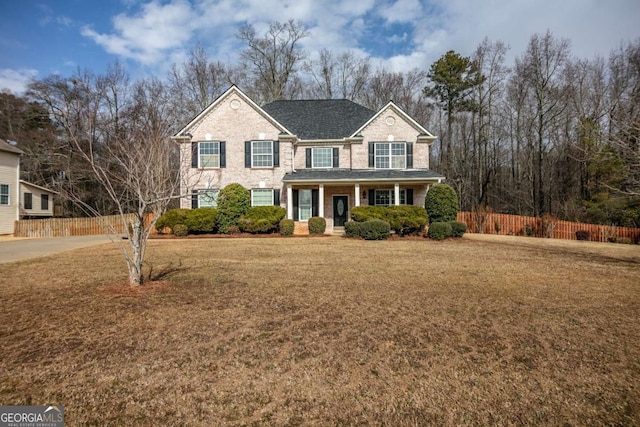 view of front of home with a front yard and a porch