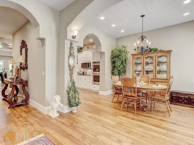 dining area featuring a chandelier and light hardwood / wood-style floors