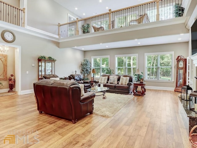 living room with a high ceiling and light wood-type flooring