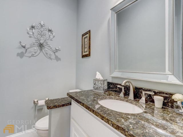 bathroom featuring toilet and vanity