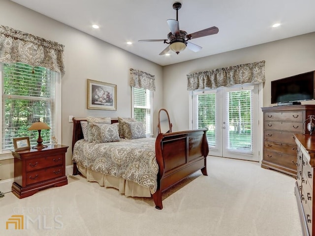 bedroom featuring ceiling fan, light colored carpet, french doors, and access to outside