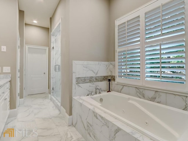 bathroom with vanity and shower with separate bathtub