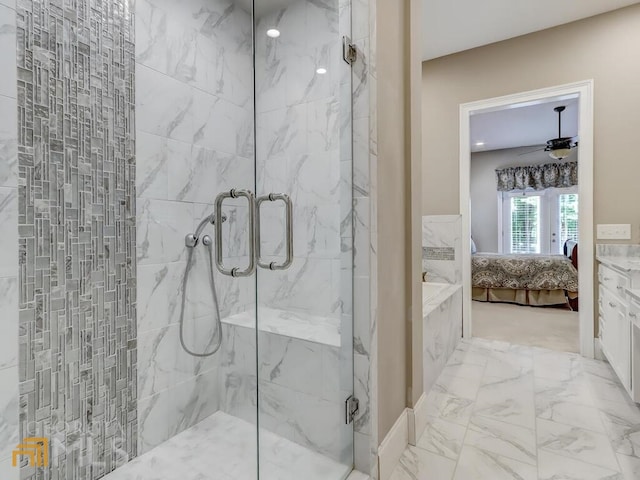 bathroom featuring ceiling fan and a shower with door