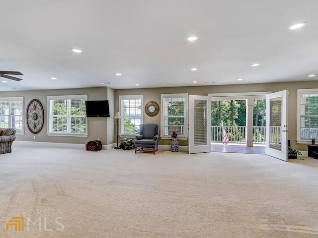 interior space featuring carpet, french doors, and ceiling fan