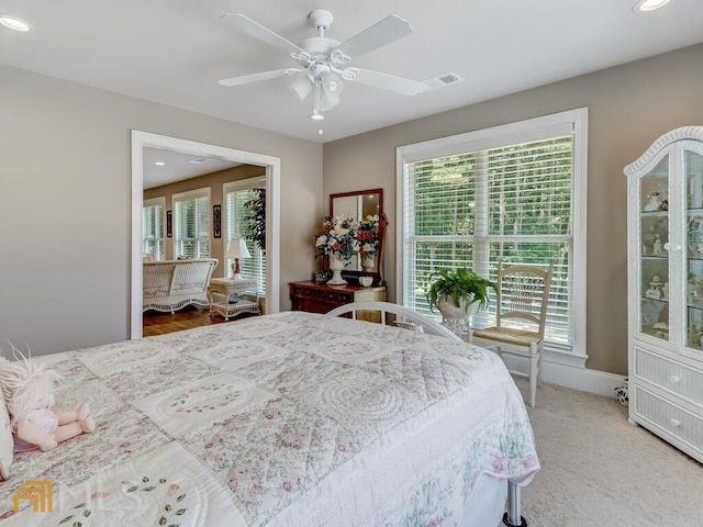 bedroom with ceiling fan and multiple windows