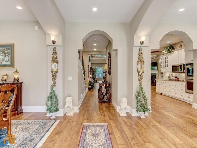 corridor with light hardwood / wood-style floors