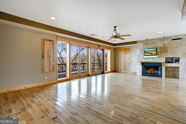 unfurnished living room with ceiling fan and light hardwood / wood-style floors