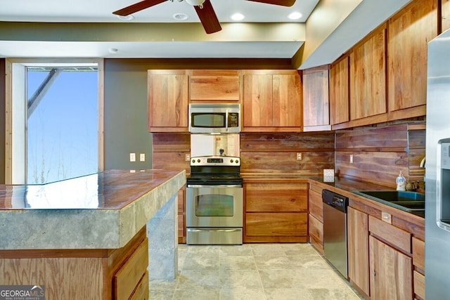 kitchen with ceiling fan, sink, and stainless steel appliances