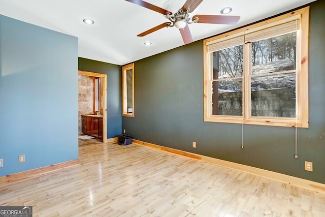 empty room with ceiling fan and light wood-type flooring