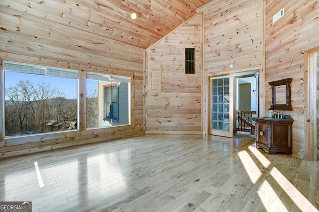 interior space with wood walls, wood ceiling, light hardwood / wood-style flooring, and high vaulted ceiling