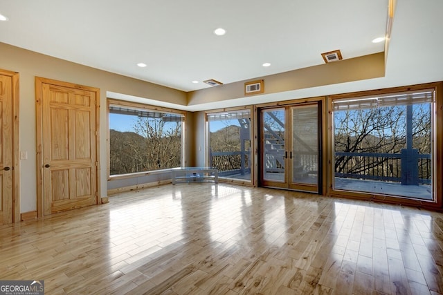 empty room featuring light hardwood / wood-style floors and french doors