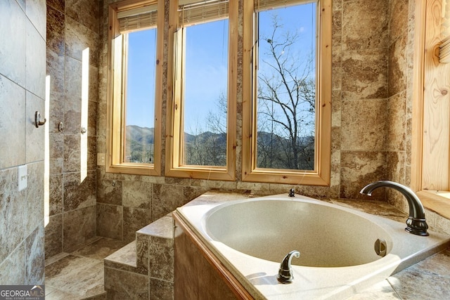 bathroom featuring tiled bath