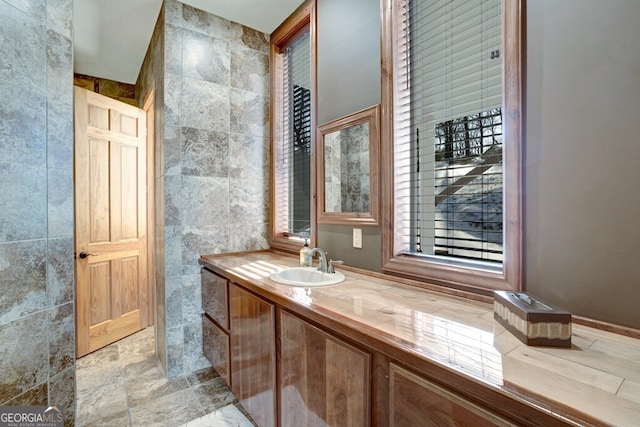 bathroom featuring tile walls and vanity