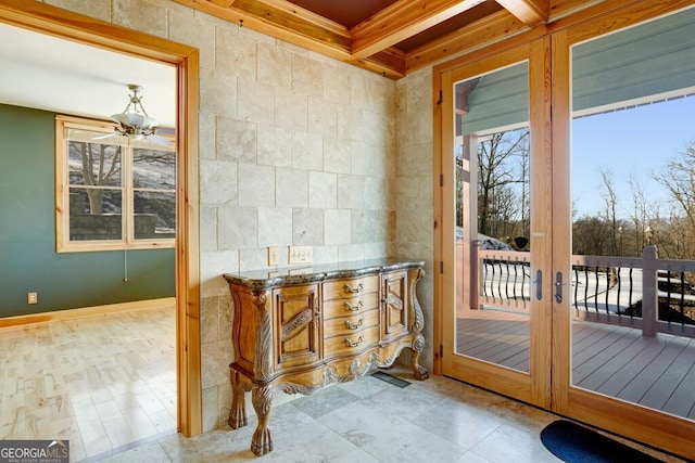 entryway with coffered ceiling, ceiling fan, beam ceiling, and french doors