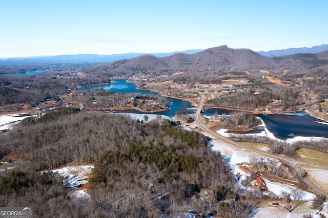 drone / aerial view featuring a water and mountain view