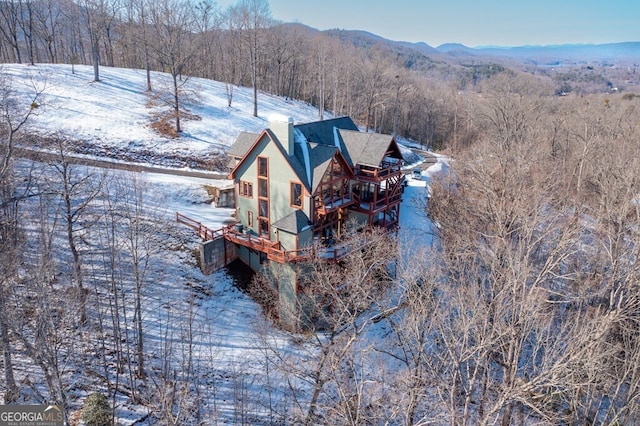 snowy aerial view with a mountain view