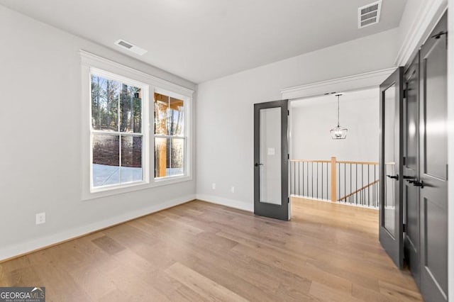 spare room featuring wood-type flooring