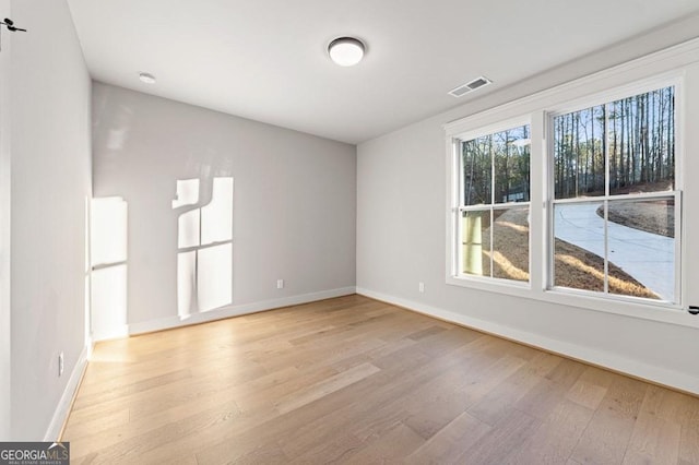 spare room featuring light hardwood / wood-style floors