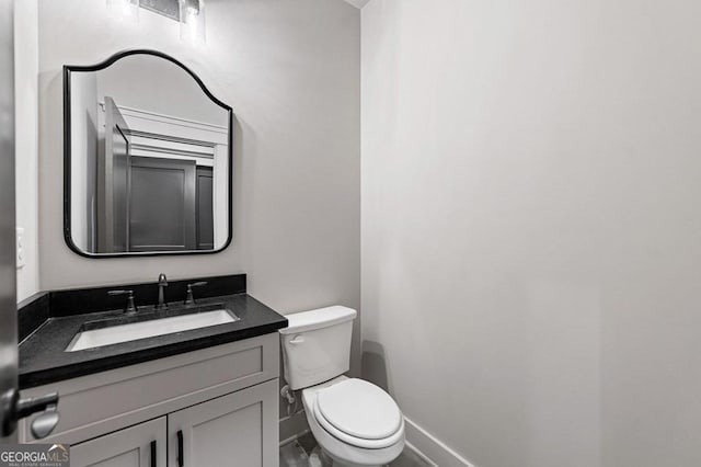 bathroom with toilet and vanity