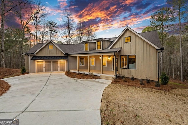 view of front of home featuring a yard, a porch, and a garage