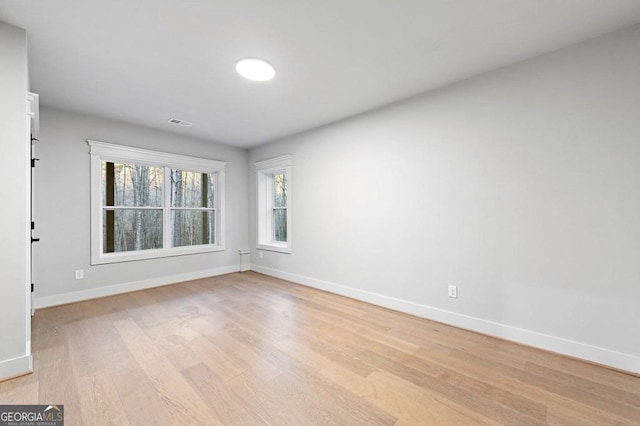 unfurnished room featuring light hardwood / wood-style floors