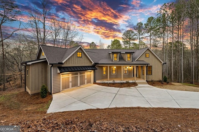 view of front of property featuring covered porch and a garage