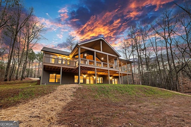 view of back house at dusk