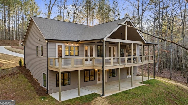 rear view of property with a yard, french doors, and a patio