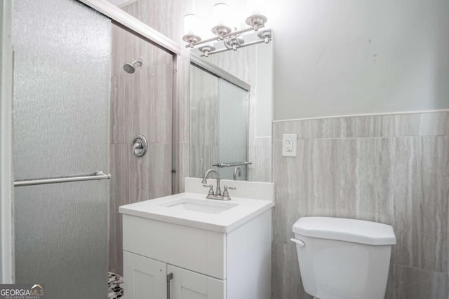 bathroom featuring toilet, vanity, and walk in shower