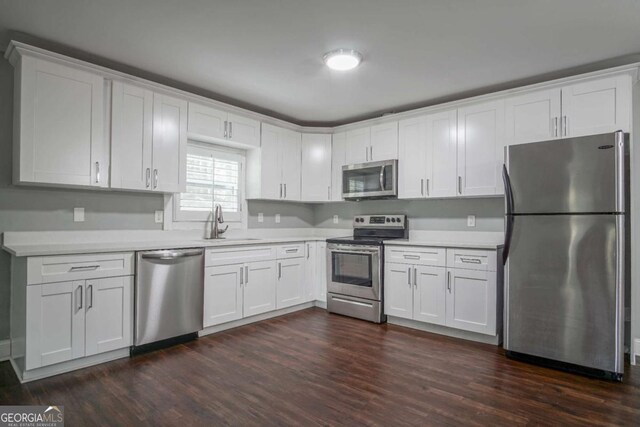 kitchen featuring white cabinets, dark hardwood / wood-style floors, sink, and stainless steel appliances