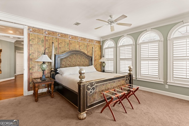 bedroom with ceiling fan, ornamental molding, and carpet flooring
