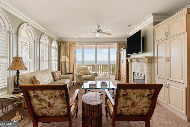interior space featuring ceiling fan, a high end fireplace, and crown molding