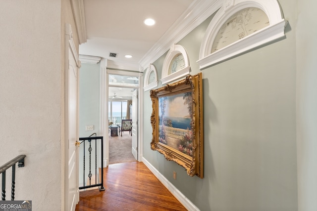 corridor with dark hardwood / wood-style flooring and crown molding