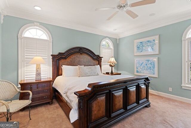 carpeted bedroom with ceiling fan and ornamental molding
