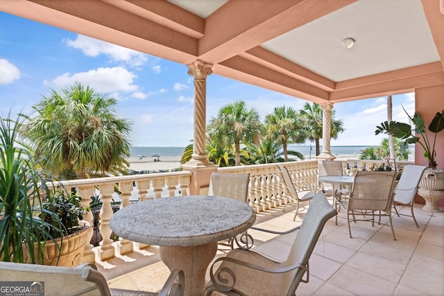 view of patio featuring a water view and a view of the beach