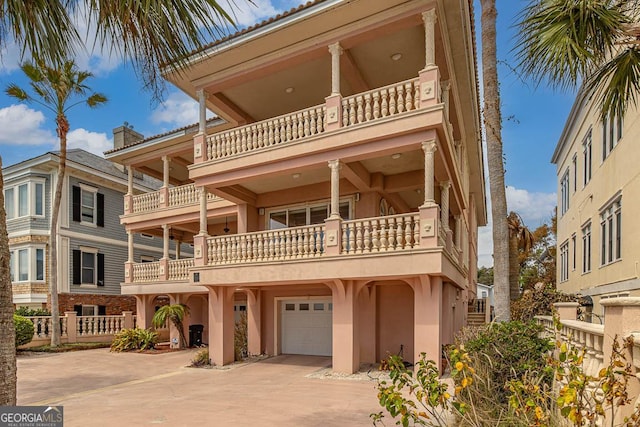 view of front facade with a garage and a balcony