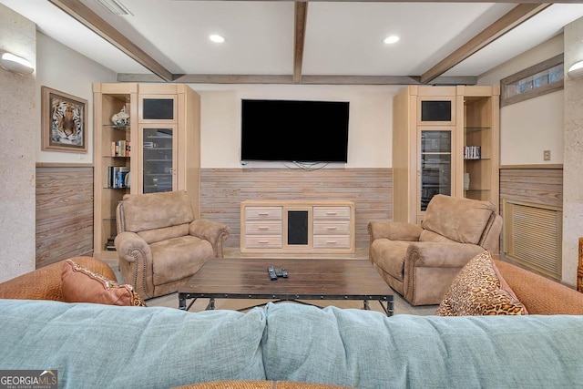 living room with wooden walls and beamed ceiling