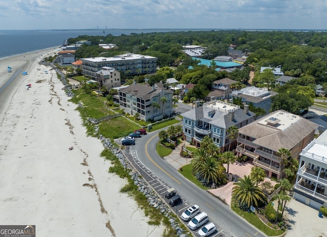 drone / aerial view featuring a water view and a view of the beach