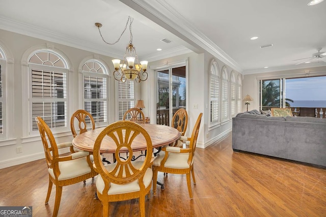 dining room featuring ceiling fan with notable chandelier, ornamental molding, and light wood-type flooring