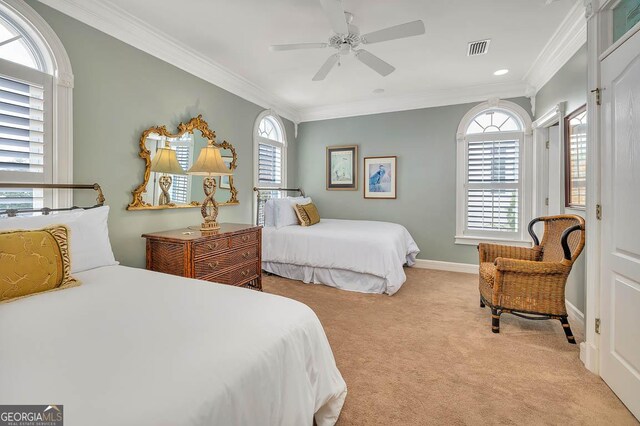 carpeted bedroom with ceiling fan, crown molding, and multiple windows