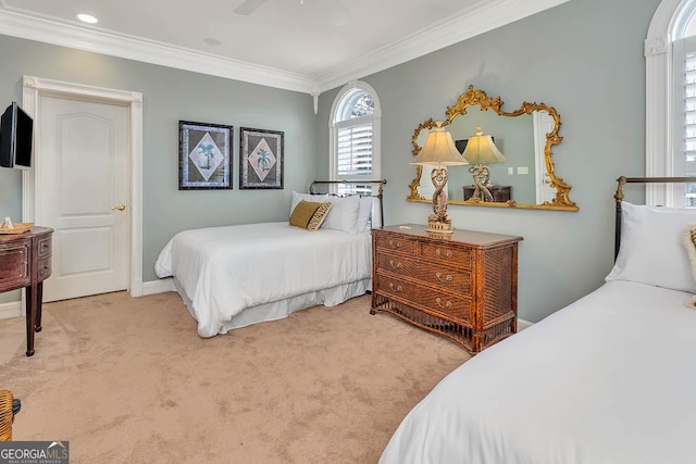 bedroom with ceiling fan, ornamental molding, and carpet flooring