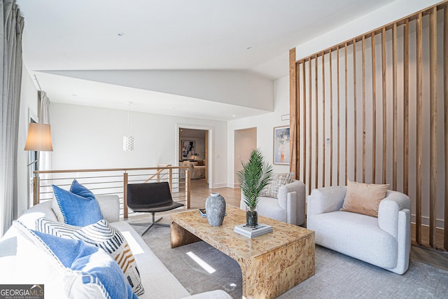 living room featuring lofted ceiling and light hardwood / wood-style flooring