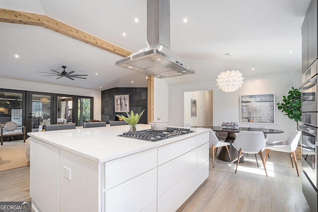 kitchen featuring white cabinetry, island range hood, a center island, light hardwood / wood-style flooring, and stainless steel appliances