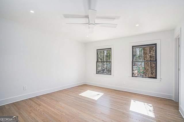 empty room featuring ceiling fan and light hardwood / wood-style flooring