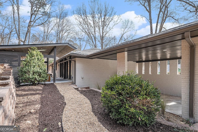 view of side of home with a patio area