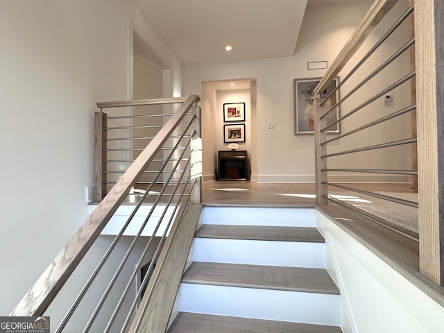 stairs with hardwood / wood-style floors