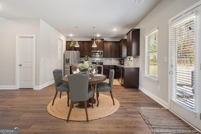 dining area featuring dark hardwood / wood-style flooring