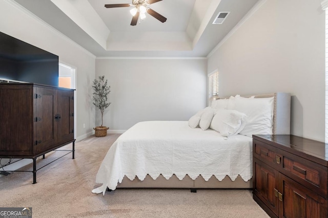 carpeted bedroom with ceiling fan and a tray ceiling