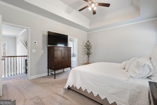 bedroom with ceiling fan, light carpet, a tray ceiling, and ornamental molding