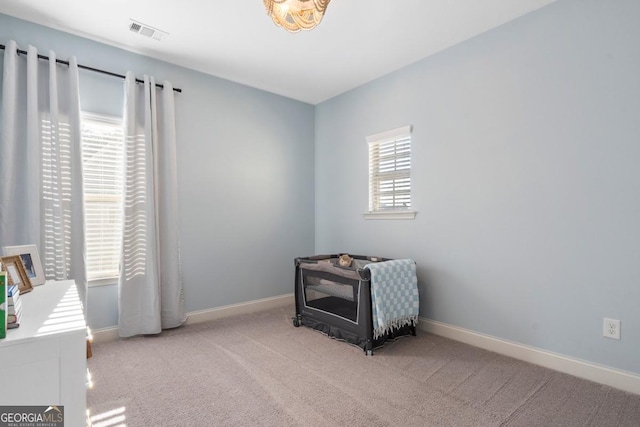 sitting room featuring light carpet